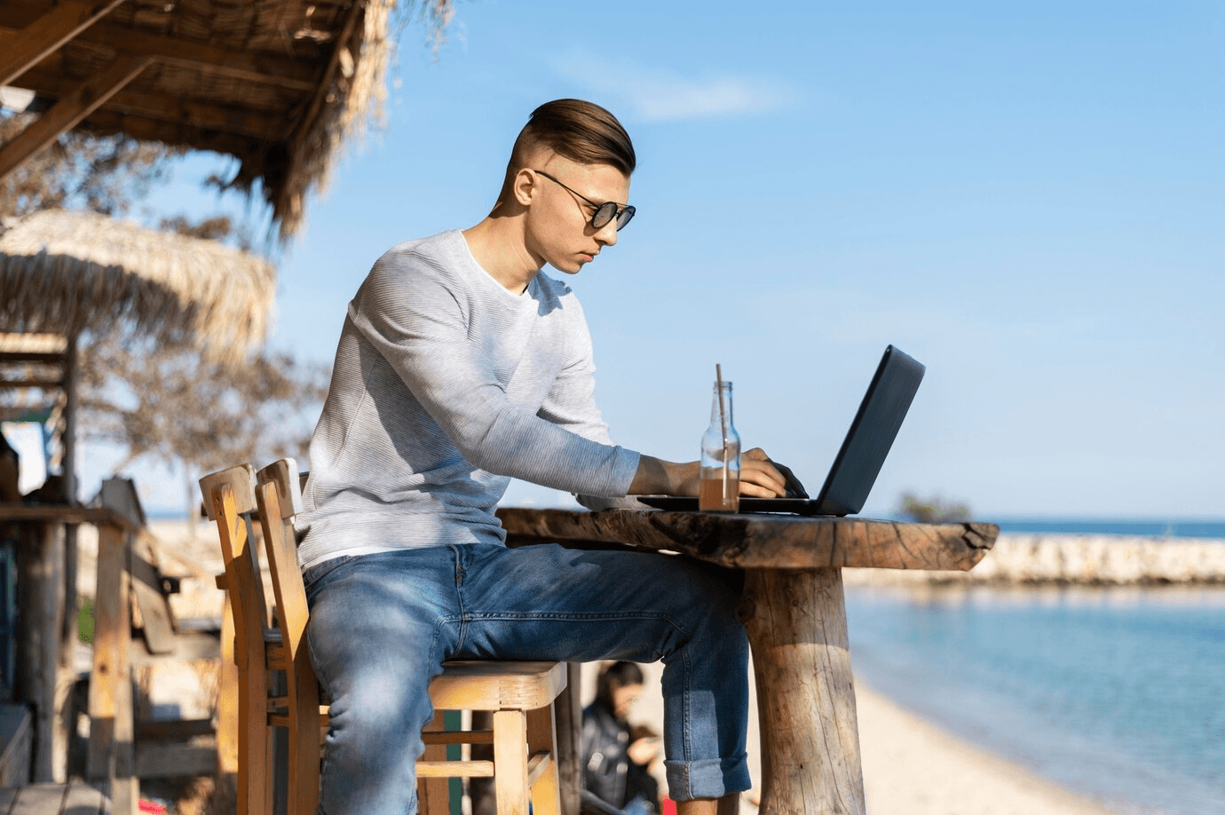 Person working on laptop at beach